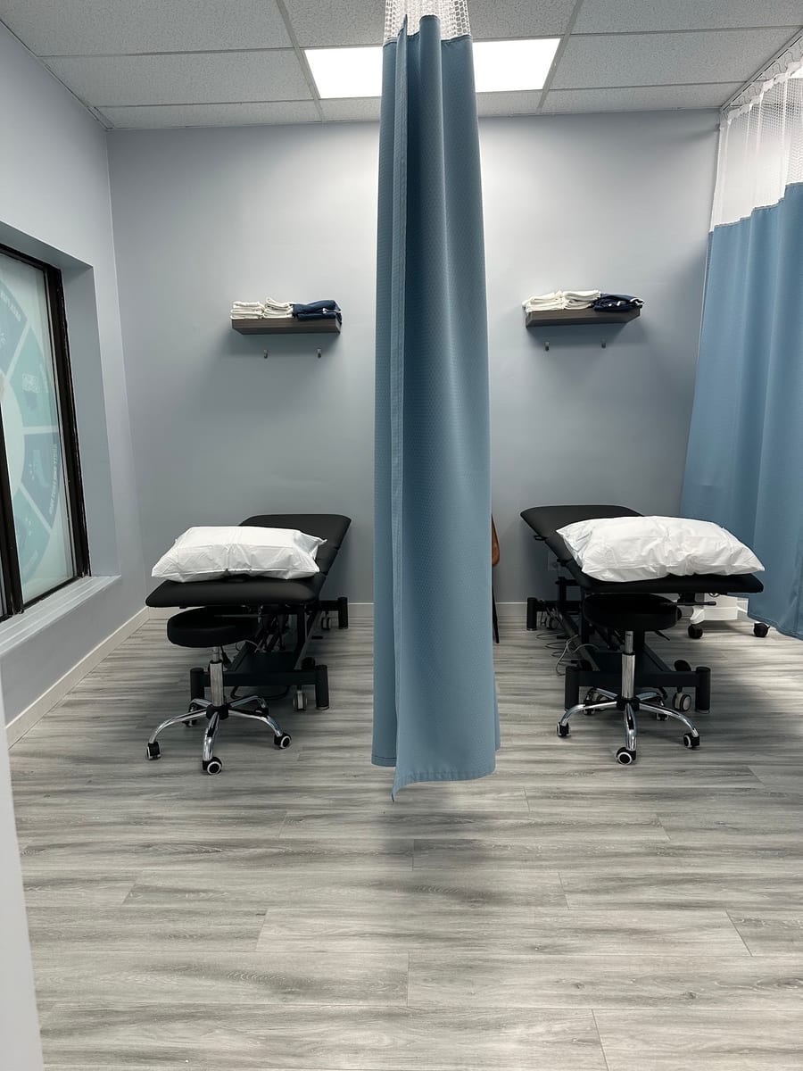Two curtained treatment bays in the Mississauga clinic