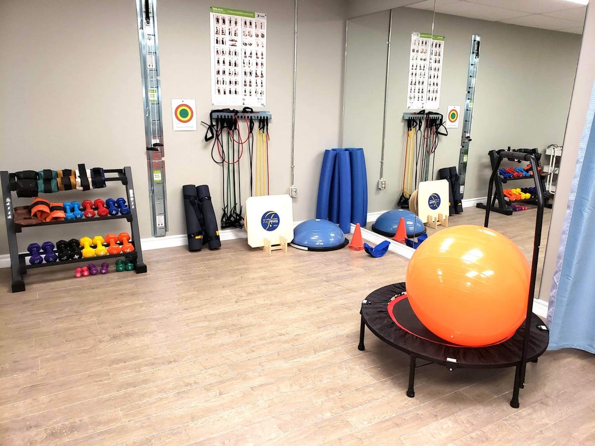 The clinic's balance and conditioning room, with dumbbells, resistance bands, a bosu and an exercise ball