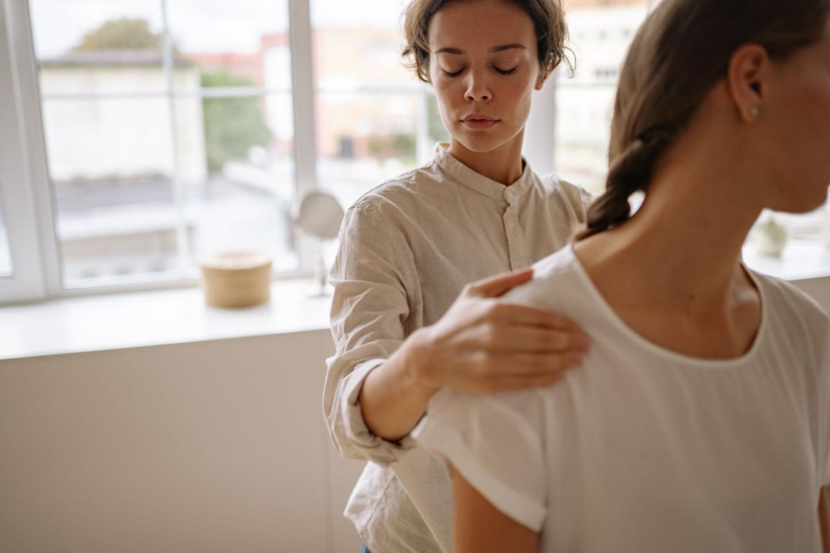 A physiotherapist guiding a patient through a supported exercise